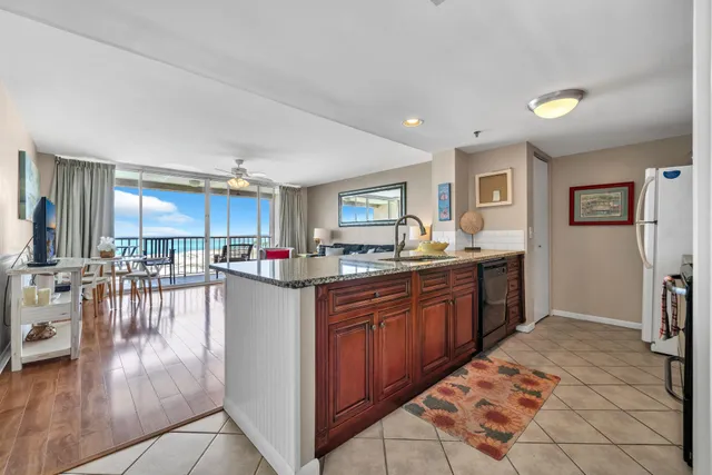 a kitchen with stainless steel appliances granite countertop a refrigerator and a sink