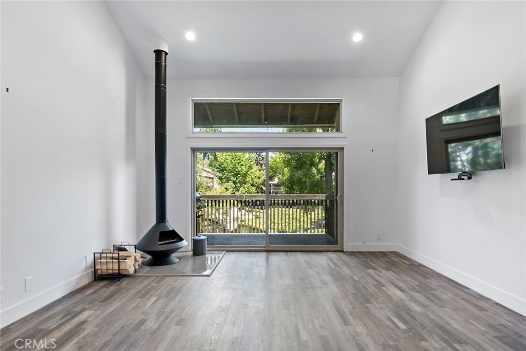 7890 East Spring Street, Unit 17D Long Beach, CA 90815 - Photo 1 of 45 an empty room with wooden floor and windows