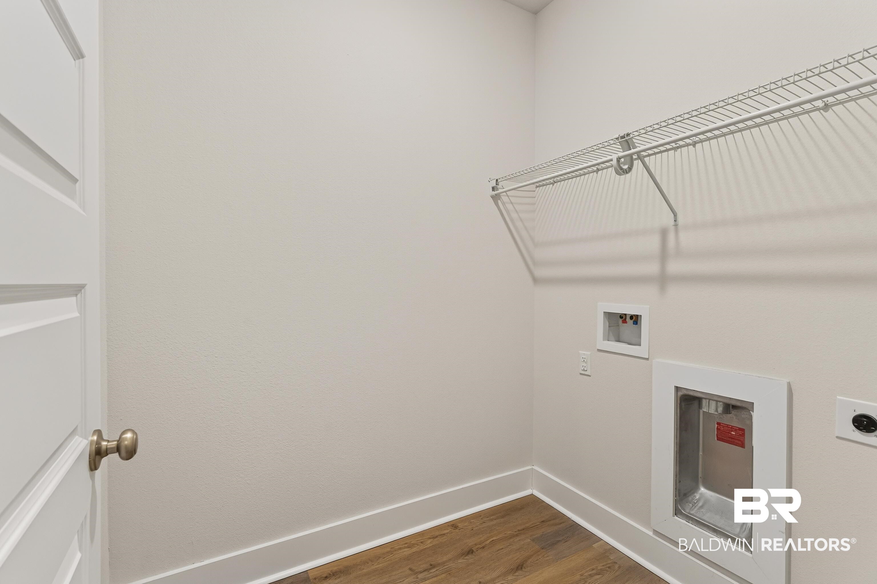 1724 Partridge Street Foley, AL 36535 - Photo 35 of 62 Dedicated laundry area featuring wood-finish flooring, white wire shelving, a washer hookup, and a dryer vent