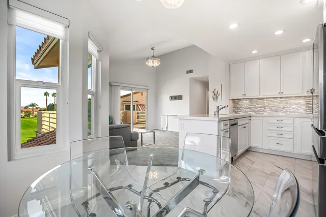 a kitchen with white cabinets and counter space