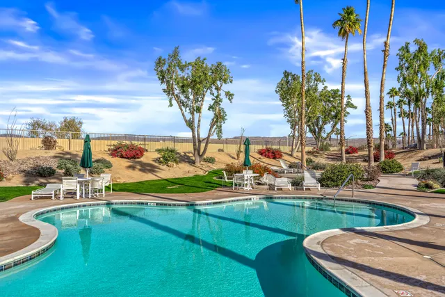 a view of a swimming pool with a yard