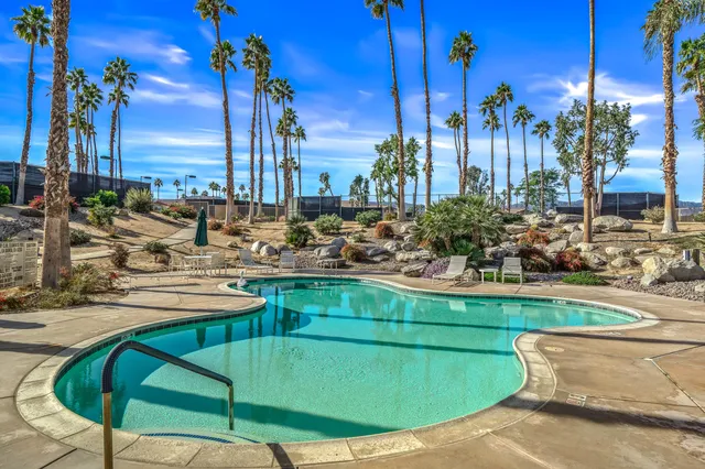 a view of a swimming pool with a lounge chairs