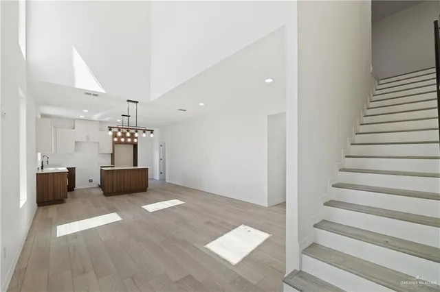 a view of kitchen and hall with wooden floor