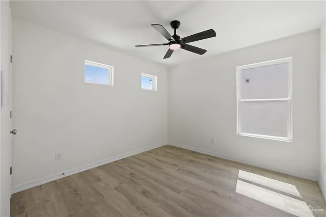 a view of a big room with wooden floor closet and windows