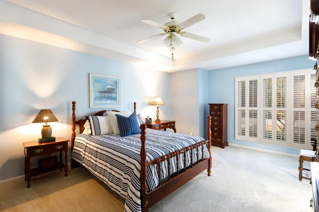 a bedroom with a bed and a chandelier