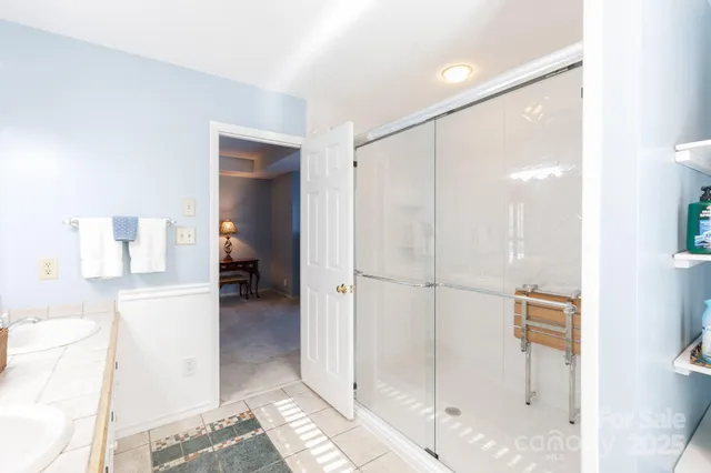 a bathroom with a glass shower door