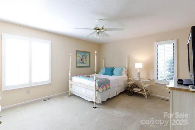 a spacious bedroom with a bed and a window