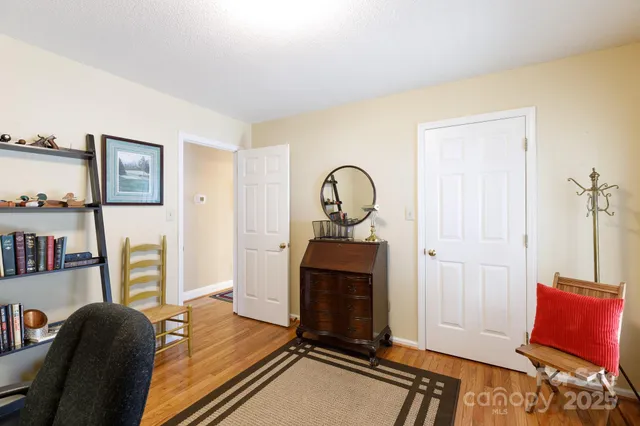 a living room with furniture a flat screen tv and a window