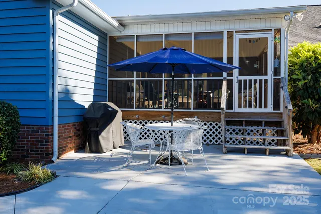 a view of a chair and table in the patio