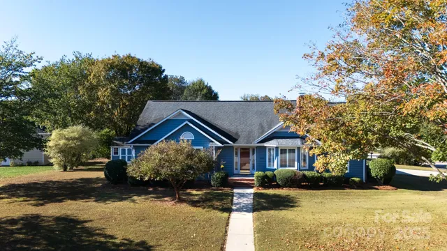 a view of house with yard