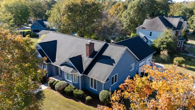 an aerial view of house with yard and swimming pool