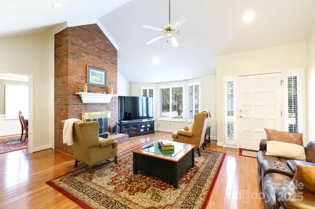 a living room with furniture fireplace and a table