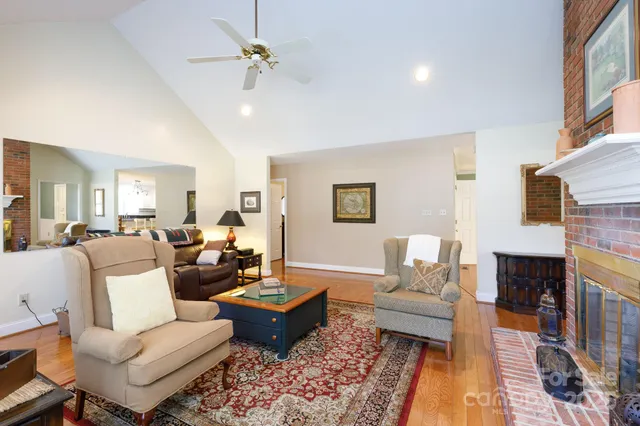 a living room with furniture fireplace and a table