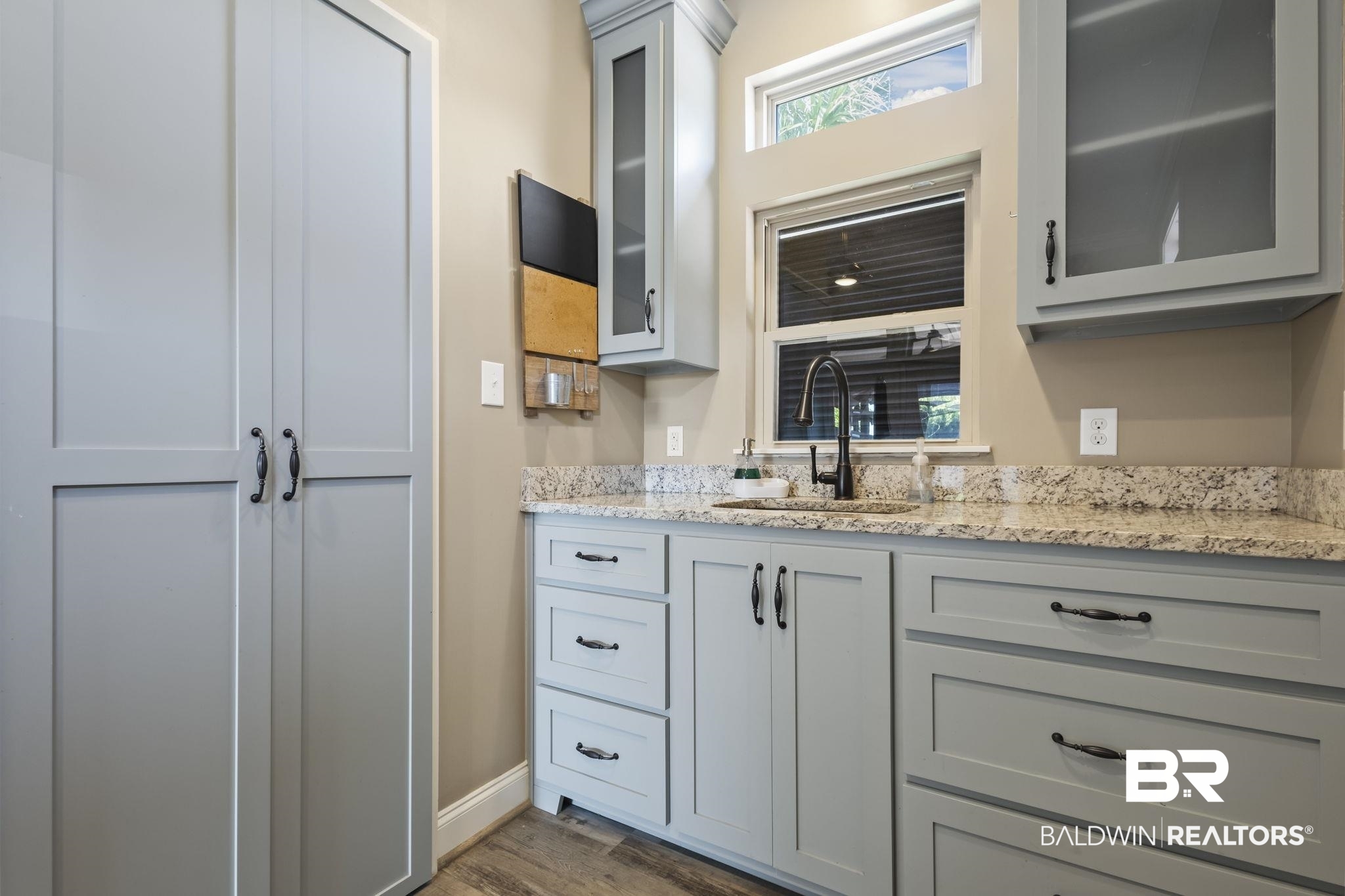 212 Magnifico Drive Foley, AL 36535 - Photo 25 of 50 Kitchen featuring dark hardwood / wood-style floors, light stone countertops, gray cabinetry, and sink
