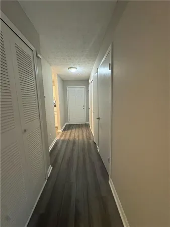 a view of a hallway with wooden floor