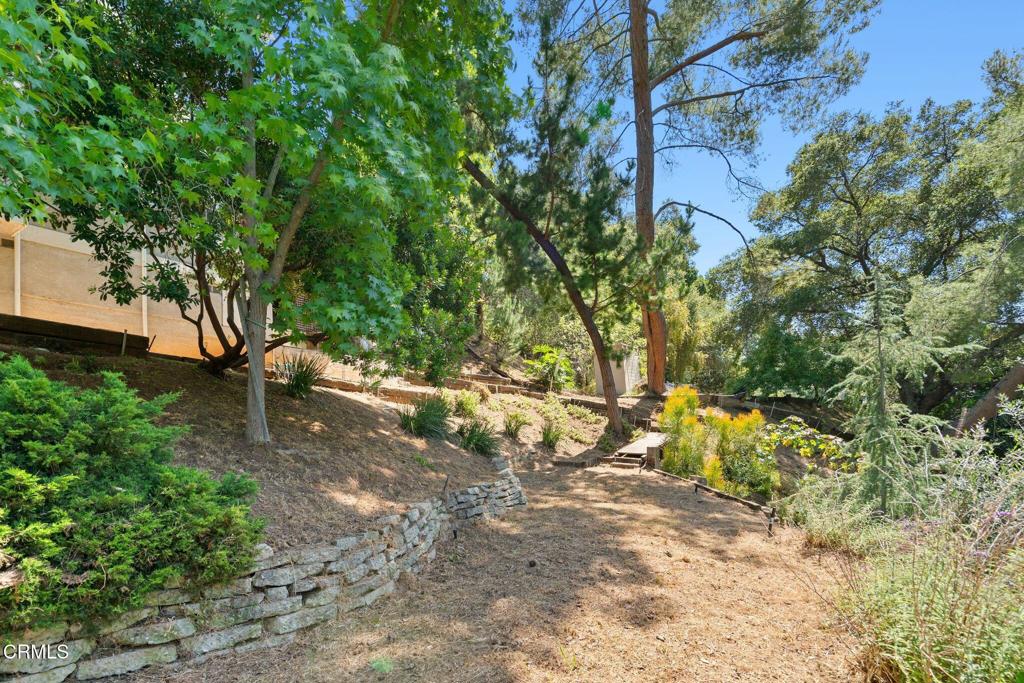 405 Woodcliffe Road Pasadena, CA 91105 - Photo 61 of 65 a backyard of a house with lots of green space