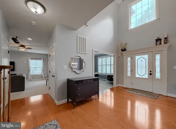 a kitchen with stainless steel appliances granite countertop a sink a stove and a wooden floor