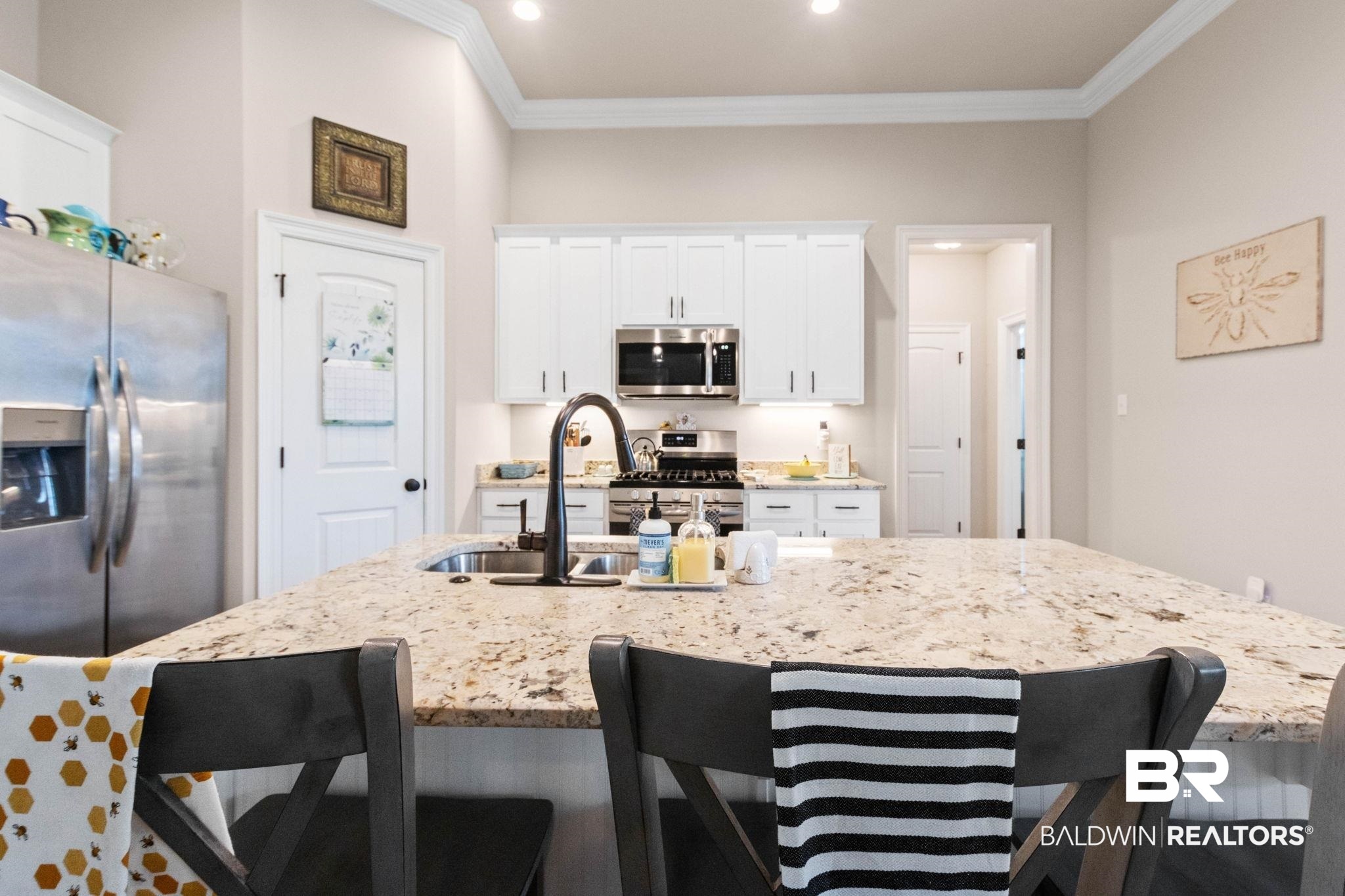 22244 Hibiscus Circle Foley, AL 36535 - Photo 28 of 51 Kitchen featuring a large light-toned granite island with seating, white shaker-style cabinetry, recessed lighting, and stainless steel appliances