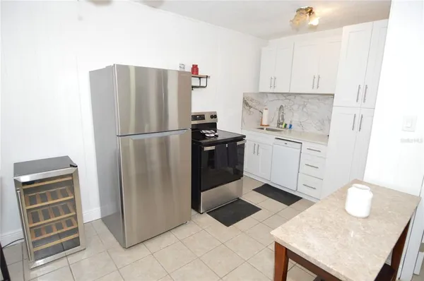 a kitchen with a refrigerator a stove a sink and a refrigerator