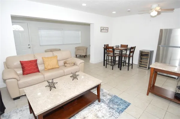 a living room with furniture and a dining table