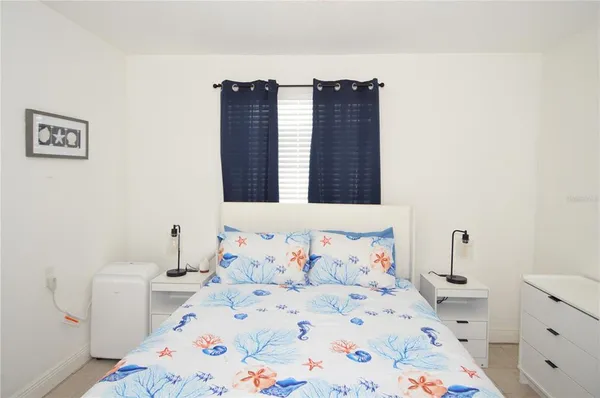 a bedroom with a bed and dresser