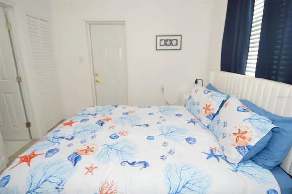 a bedroom with a bed and a window