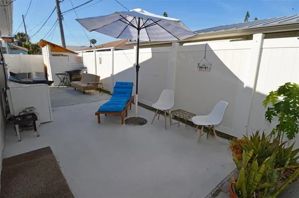 a view of a house with backyard and a chair