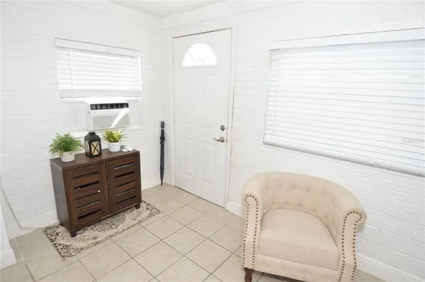 a room with a window and a dresser