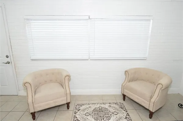 a bathroom with a bathtub and a chair