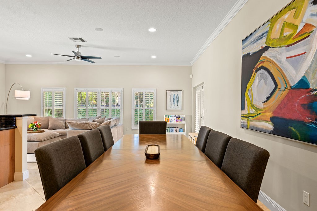 2134 Northwest Tilia Trail Stuart, FL 34994 - Photo 11 of 36 a living room with furniture floor to ceiling window and a flat screen tv
