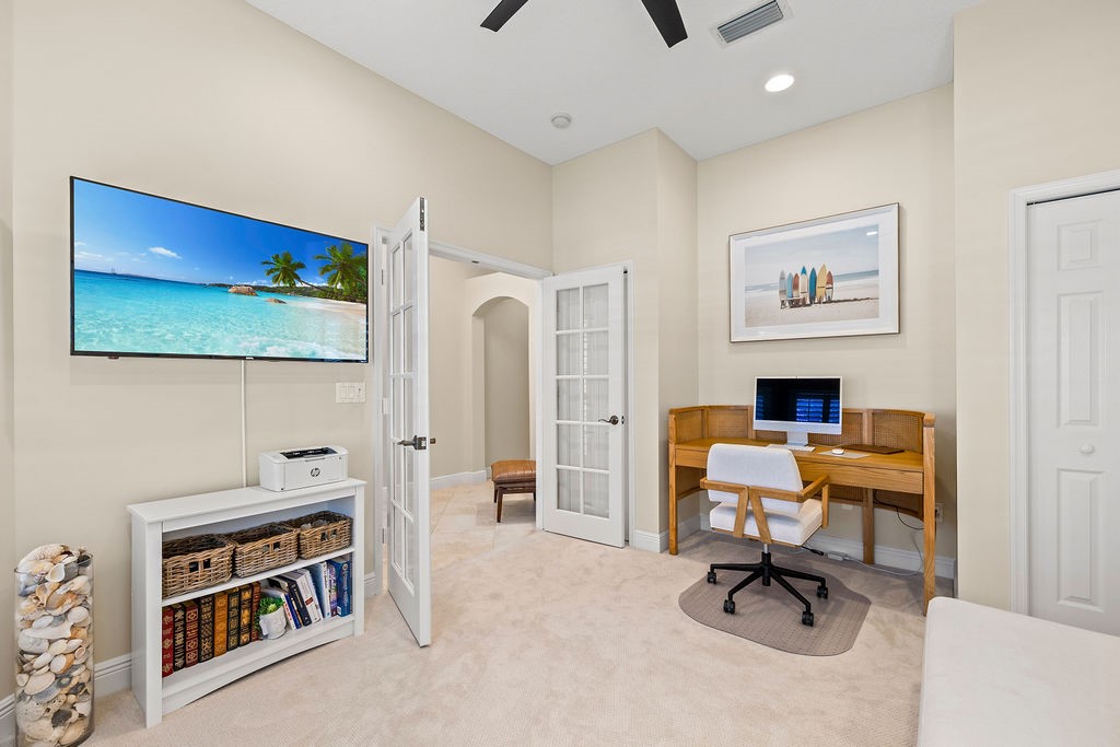 2134 Northwest Tilia Trail Stuart, FL 34994 - Photo 14 of 36 a view of a livingroom with workspace and a couch