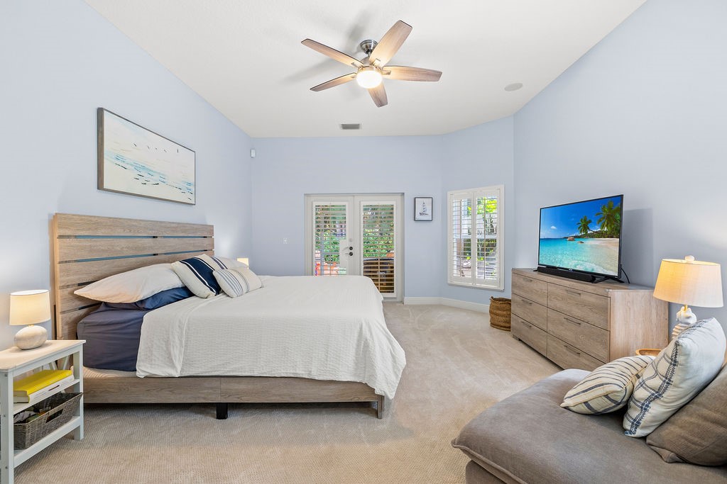 2134 Northwest Tilia Trail Stuart, FL 34994 - Photo 15 of 36 a bedroom with a bed and a flat screen tv