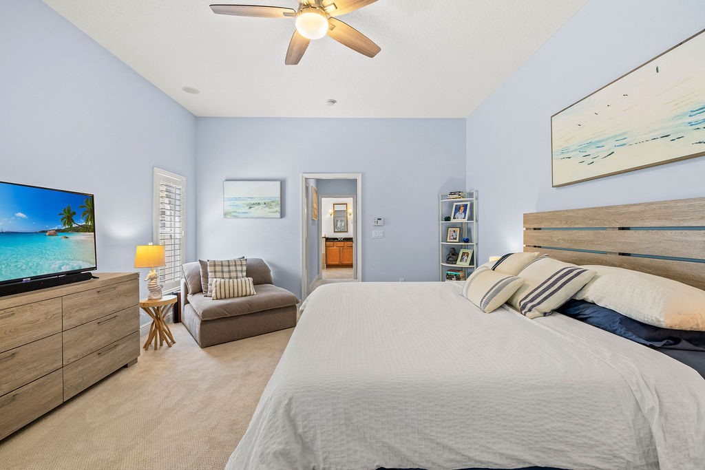 2134 Northwest Tilia Trail Stuart, FL 34994 - Photo 17 of 36 a bedroom with a bed and a flat screen tv