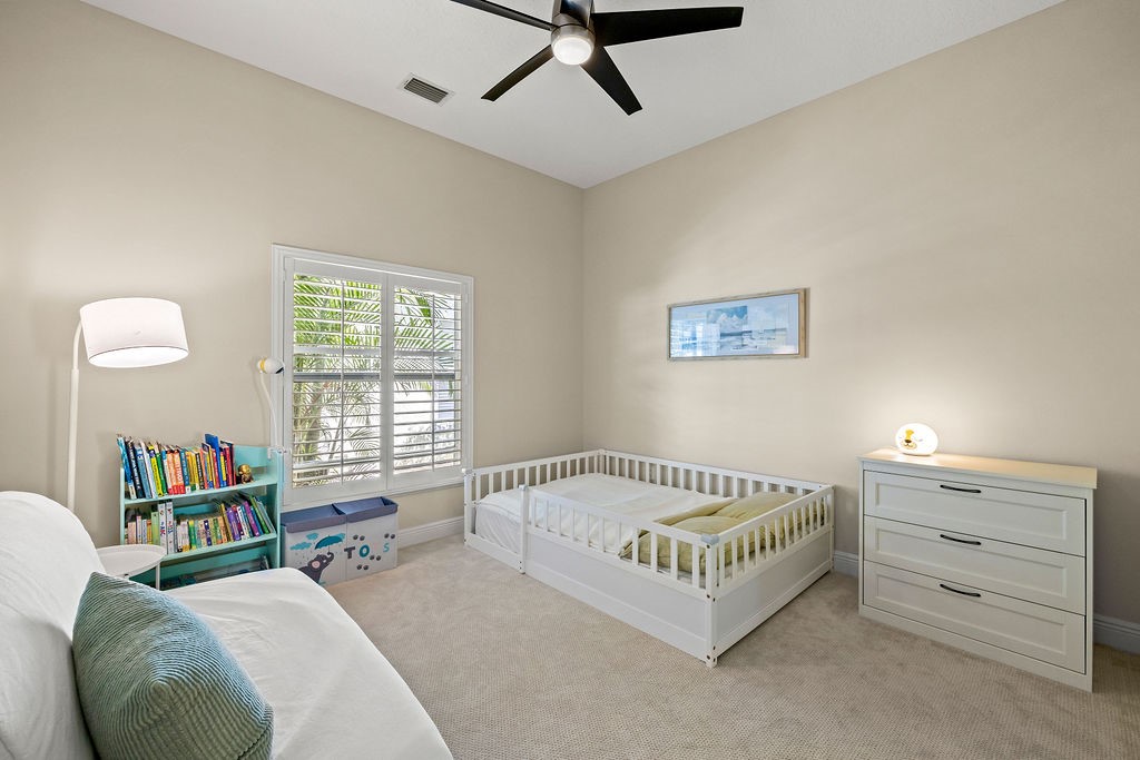 2134 Northwest Tilia Trail Stuart, FL 34994 - Photo 19 of 36 a bed room with a bed and a couch