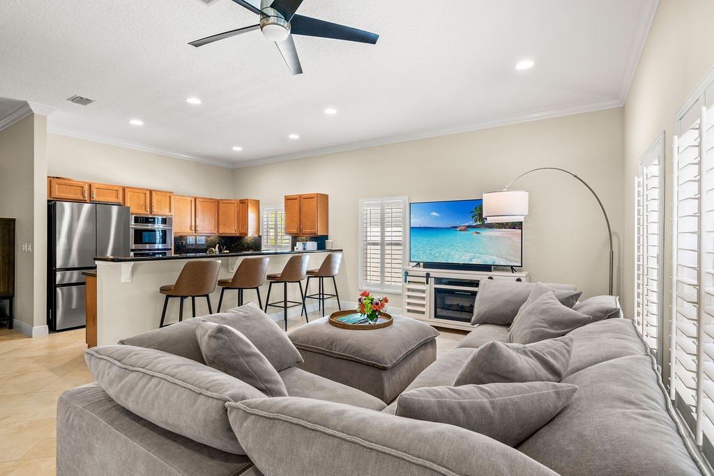 2134 Northwest Tilia Trail Stuart, FL 34994 - Photo 2 of 36 a living room with furniture kitchen view and a window