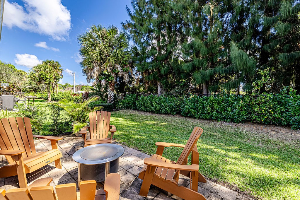 2134 Northwest Tilia Trail Stuart, FL 34994 - Photo 23 of 36 a view of a chair and table in backyard of the house