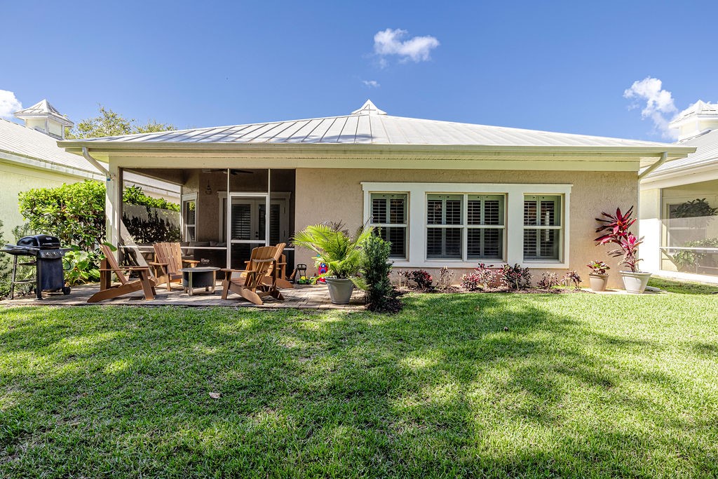 2134 Northwest Tilia Trail Stuart, FL 34994 - Photo 25 of 36 a view of a house with a backyard porch and sitting area