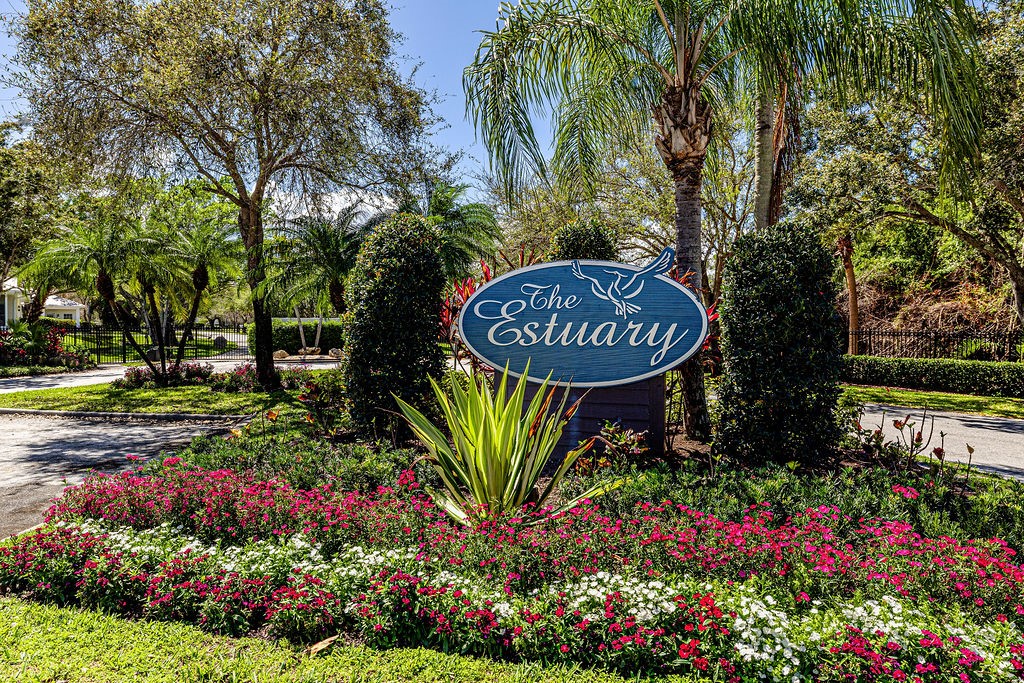 2134 Northwest Tilia Trail Stuart, FL 34994 - Photo 30 of 36 a sign that is sitting in front of flowers