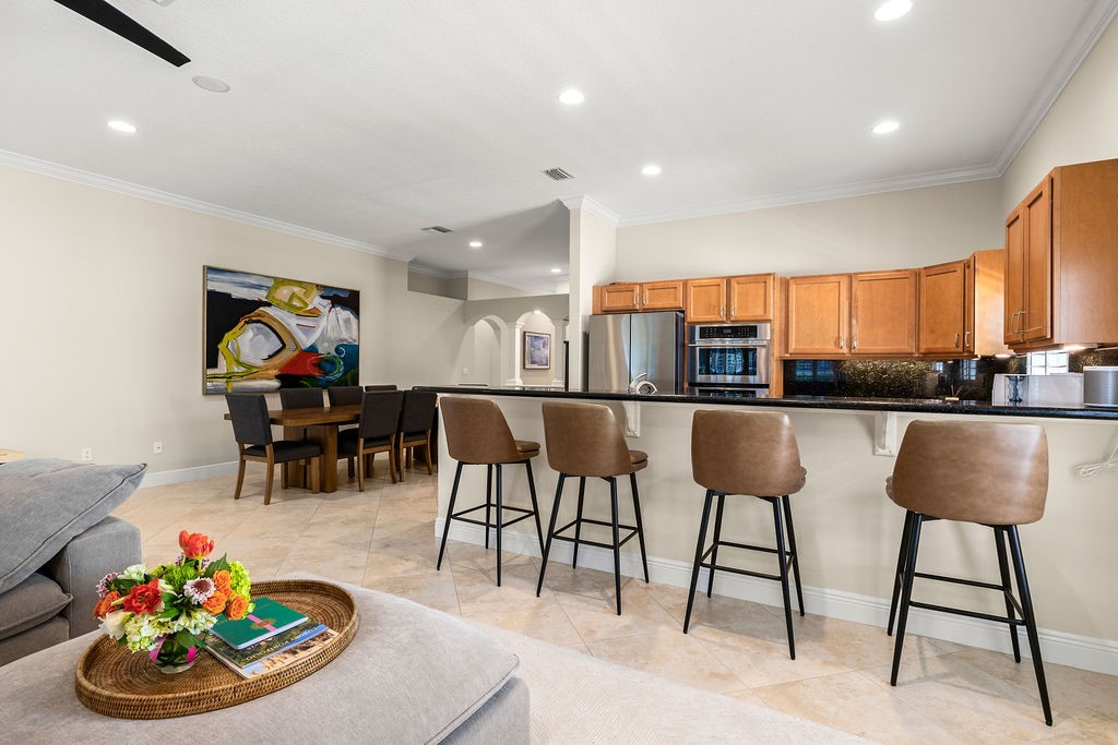 2134 Northwest Tilia Trail Stuart, FL 34994 - Photo 3 of 36 a view of a dining room with furniture