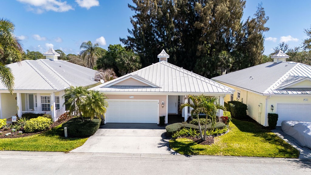 2134 Northwest Tilia Trail Stuart, FL 34994 - Photo 31 of 36 a front view of a house with garden