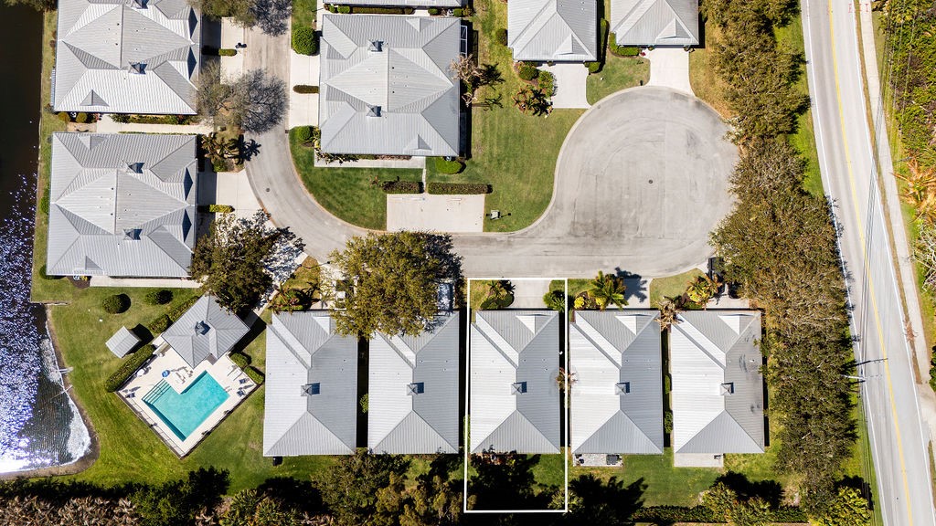 2134 Northwest Tilia Trail Stuart, FL 34994 - Photo 32 of 36 an aerial view of residential houses with outdoor space and parking