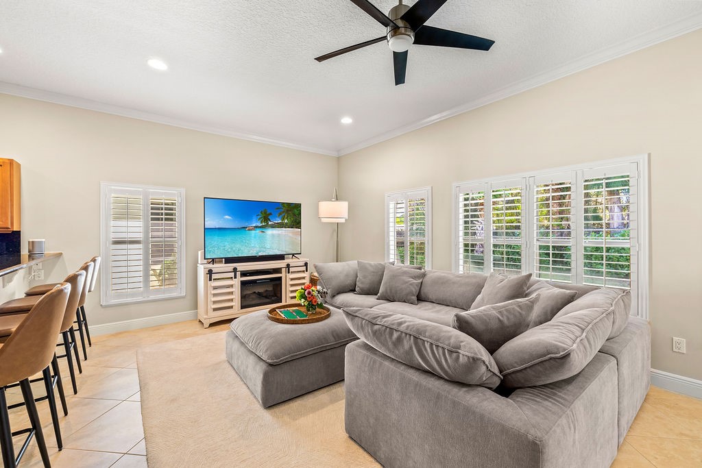2134 Northwest Tilia Trail Stuart, FL 34994 - Photo 5 of 36 a living room with furniture and a flat screen tv