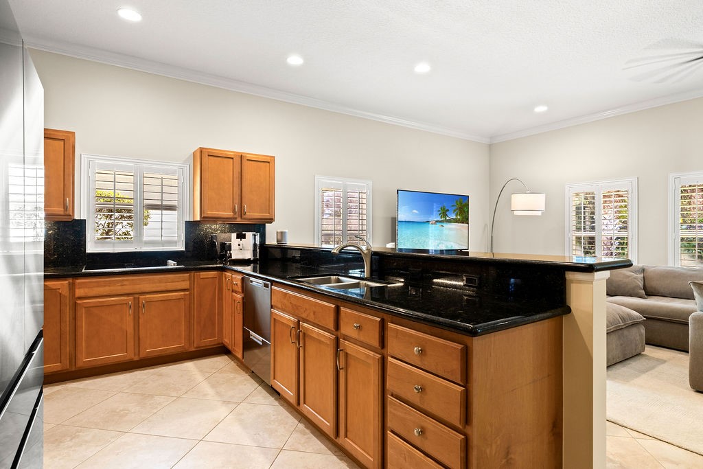 2134 Northwest Tilia Trail Stuart, FL 34994 - Photo 7 of 36 a kitchen with granite countertop a sink and white cabinets
