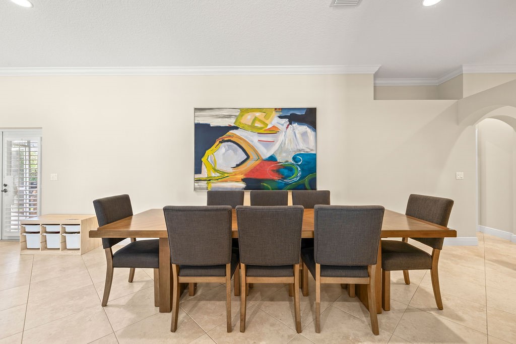 2134 Northwest Tilia Trail Stuart, FL 34994 - Photo 10 of 36 a view of a dining room with furniture