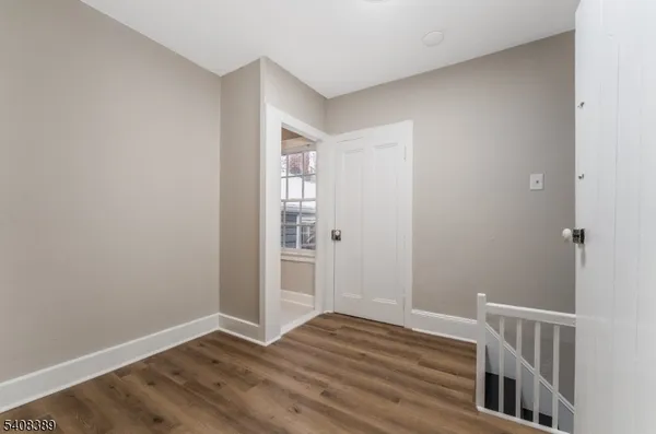 a view of hallway with wooden floor
