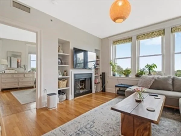 a living room with furniture a fireplace and a flat screen tv