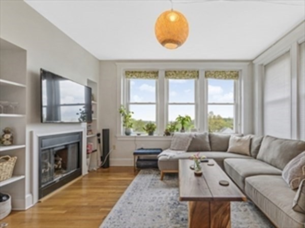 2025 Commonwealth Avenue, Unit 5 Boston, MA 02135 - Photo 3 of 13 a living room with furniture and a fireplace