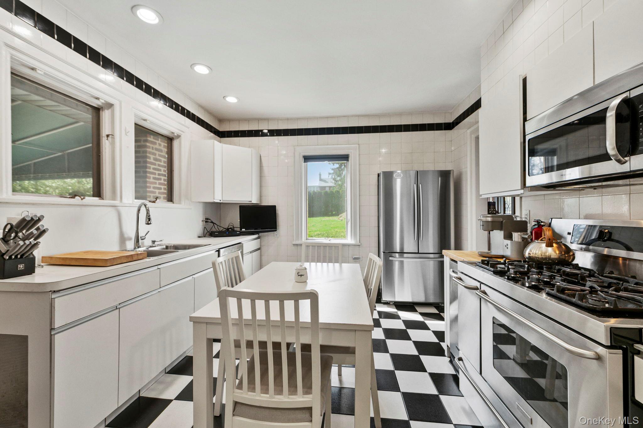 44 Fenimore Road New Rochelle, NY 10804 - Photo 11 of 46 a kitchen with a sink a stove and a refrigerator