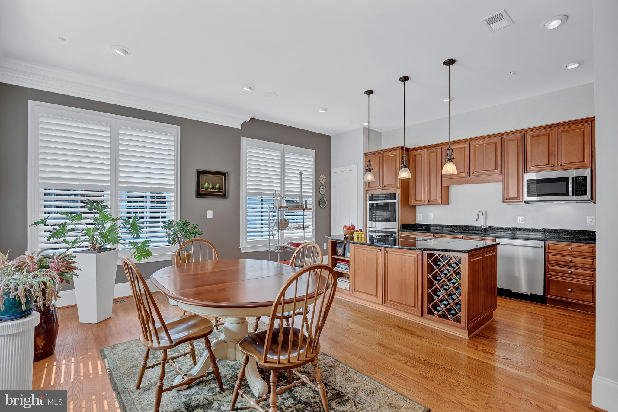 708 Day Lane Alexandria, VA 22314 - Photo 12 of 39 a kitchen with stainless steel appliances granite countertop a stove a kitchen island a dining table and chairs