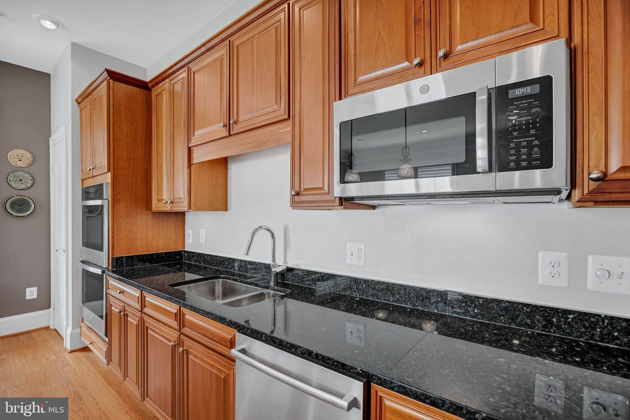 708 Day Lane Alexandria, VA 22314 - Photo 13 of 39 a kitchen with granite countertop a sink a stove and cabinets
